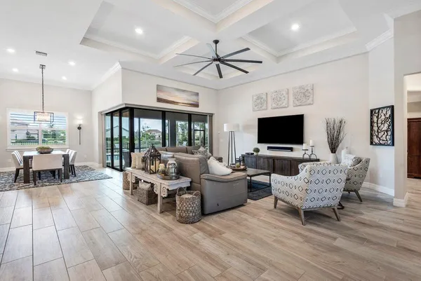 a spacious bedroom with a bed and a chandelier