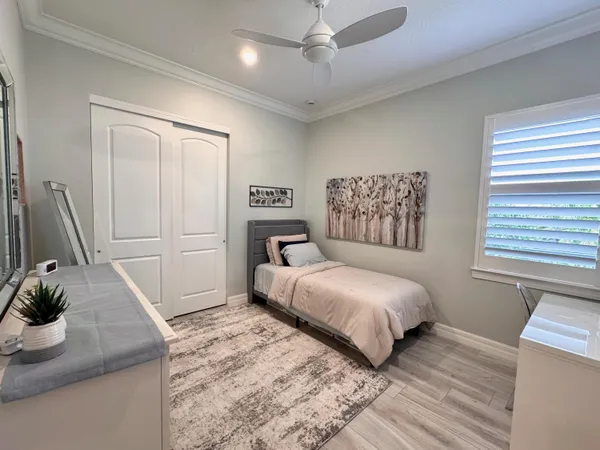 a kitchen with a sink cabinets stainless steel appliances and wooden floor