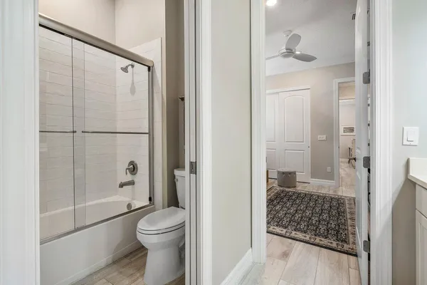 a living room with couches and a large window with balcony view