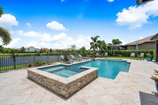 a swimming pool with outdoor seating and yard