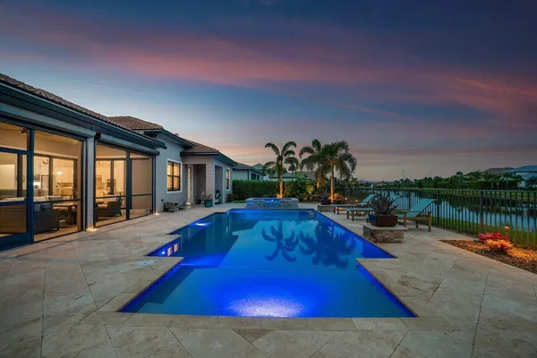 an aerial view of residential houses with outdoor space and swimming pool