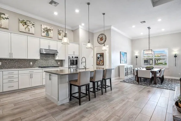 a dining room with furniture a rug and wooden floor