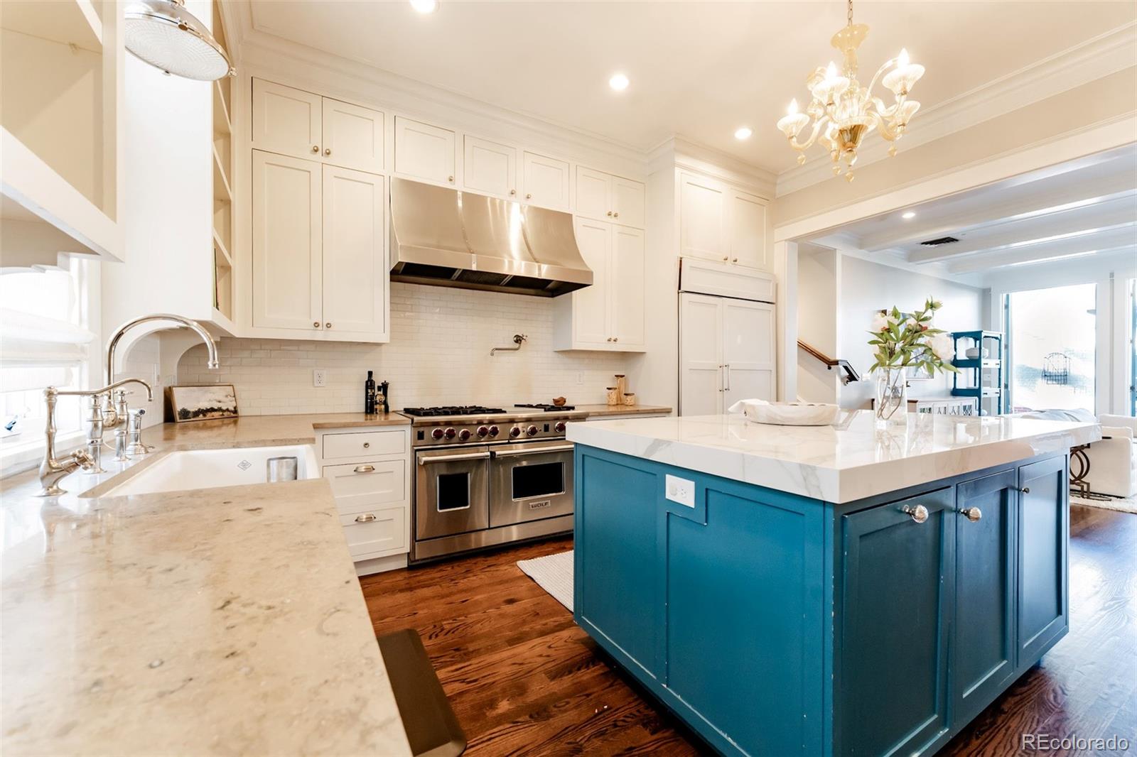 a kitchen with stainless steel appliances granite countertop a sink a stove and a refrigerator