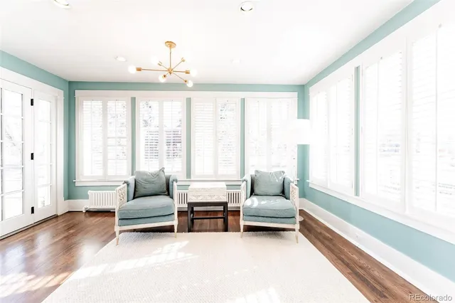 a living room with furniture and large windows