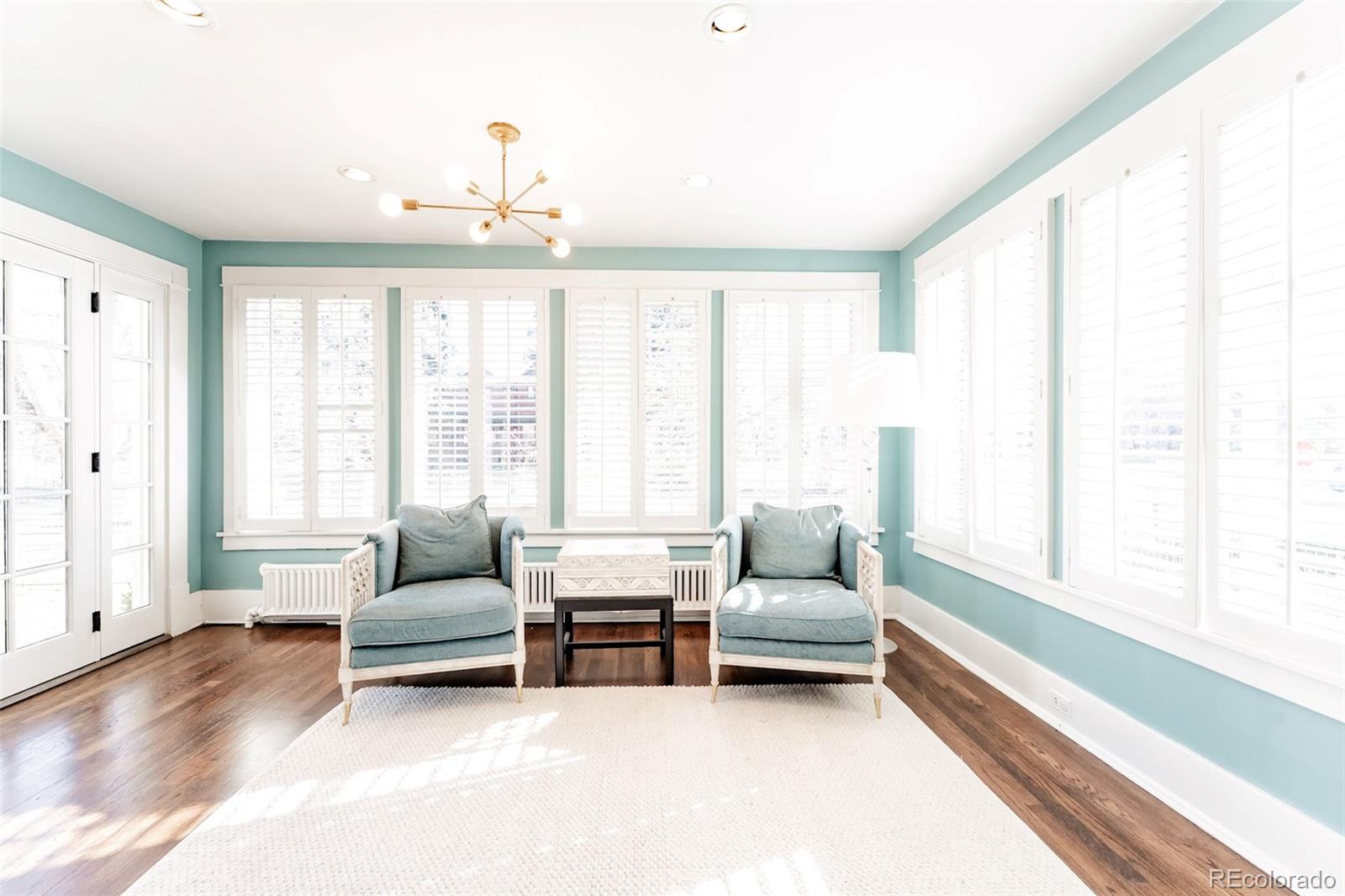 4535 Montview Boulevard Denver, CO 80207 - Photo 11 of 24 a living room with furniture and large windows