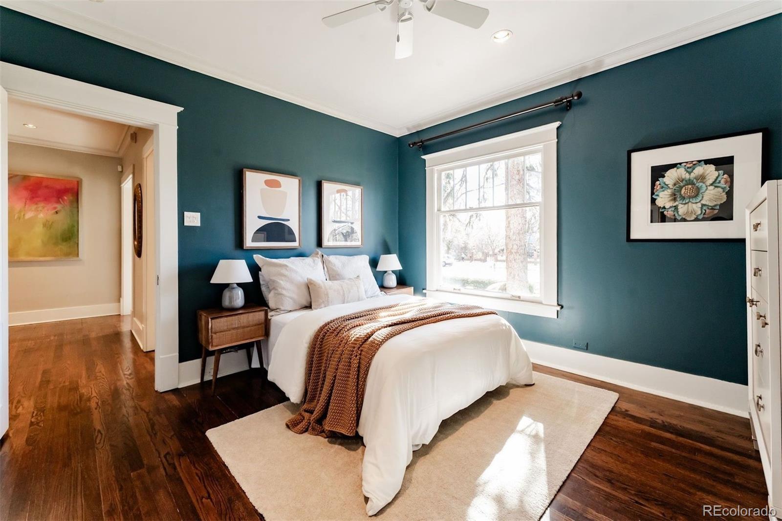 4535 Montview Boulevard Denver, CO 80207 - Photo 11 of 27 a bedroom with a bed and wooden floor