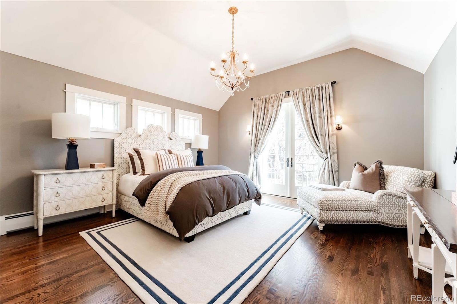 4535 Montview Boulevard Denver, CO 80207 - Photo 14 of 27 a bedroom with a bed chandelier and a window