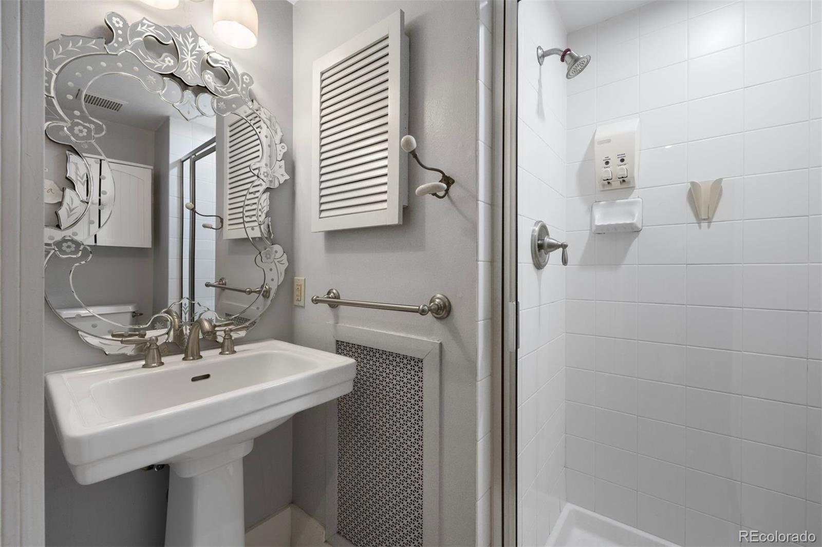 4535 Montview Boulevard Denver, CO 80207 - Photo 21 of 27 a bathroom with a sink a mirror and shower