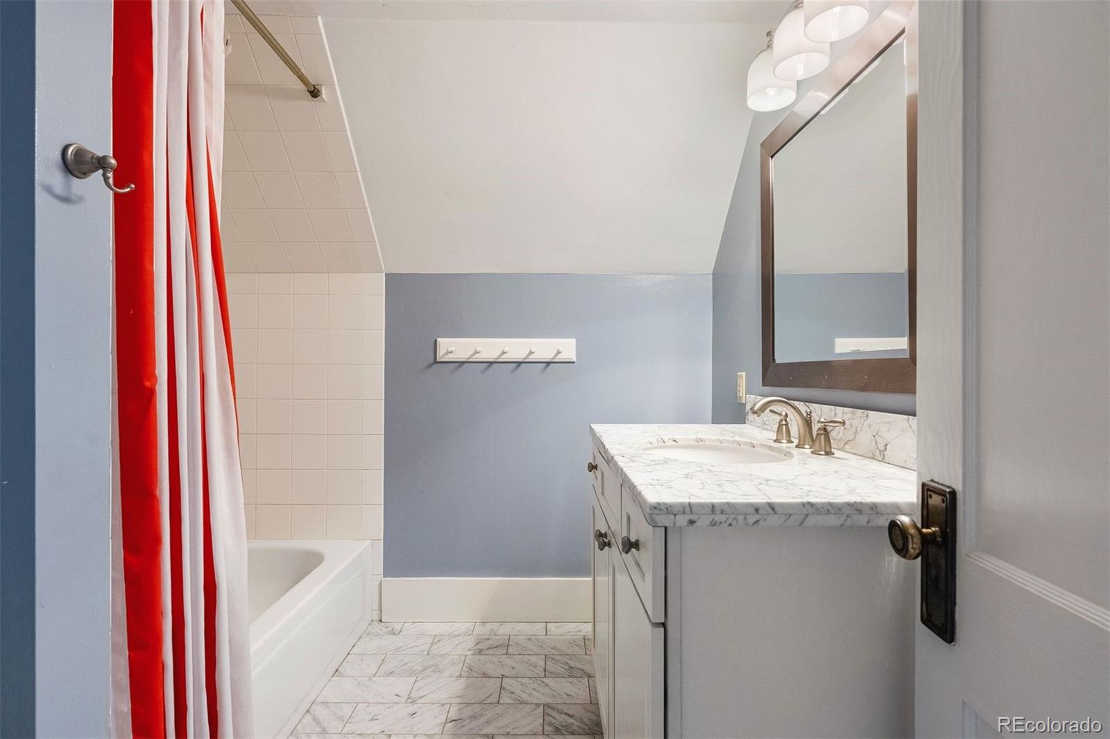 4535 Montview Boulevard Denver, CO 80207 - Photo 22 of 27 a bathroom with a sink a mirror and a shower