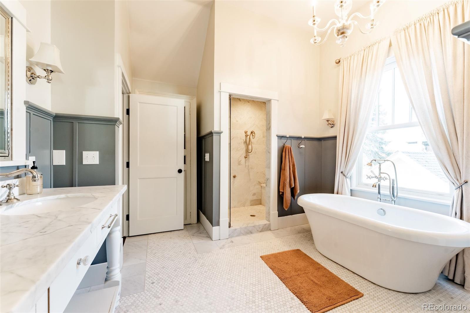 4535 Montview Boulevard Denver, CO 80207 - Photo 22 of 24 a spacious bathroom with a tub sink and mirror
