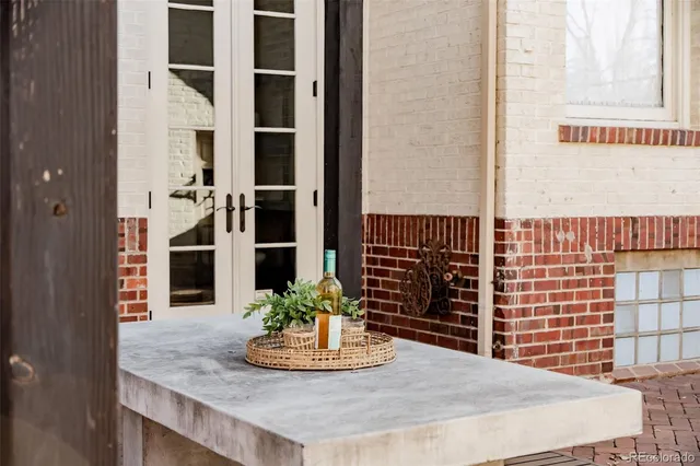 a view of a dining room with a table and chairs