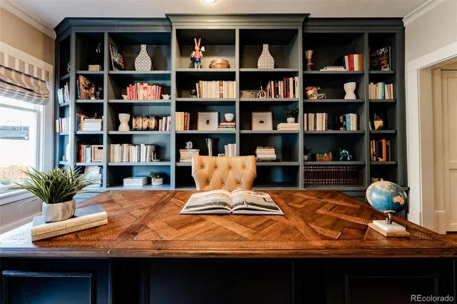 a living room with furniture and a book shelf