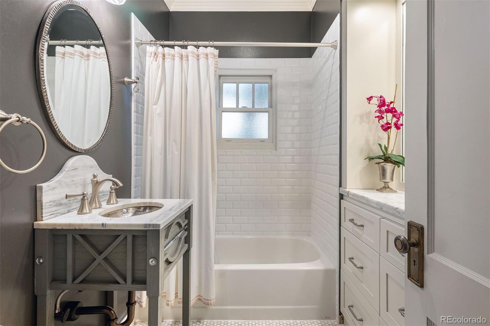 4535 Montview Boulevard Denver, CO 80207 - Photo 7 of 27 a bathroom with a sink vanity mirror and tub