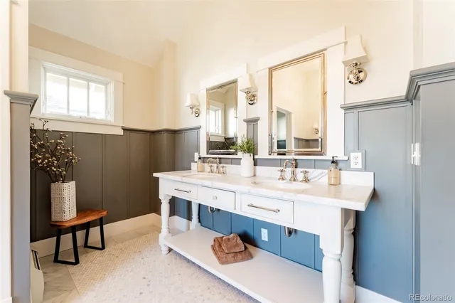 a bathroom with a double vanity sink a mirror and a shower