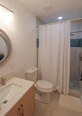 a white toilet sitting next to a bathroom sink