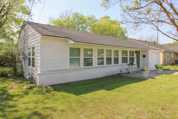 a view of a house with pool and sitting area