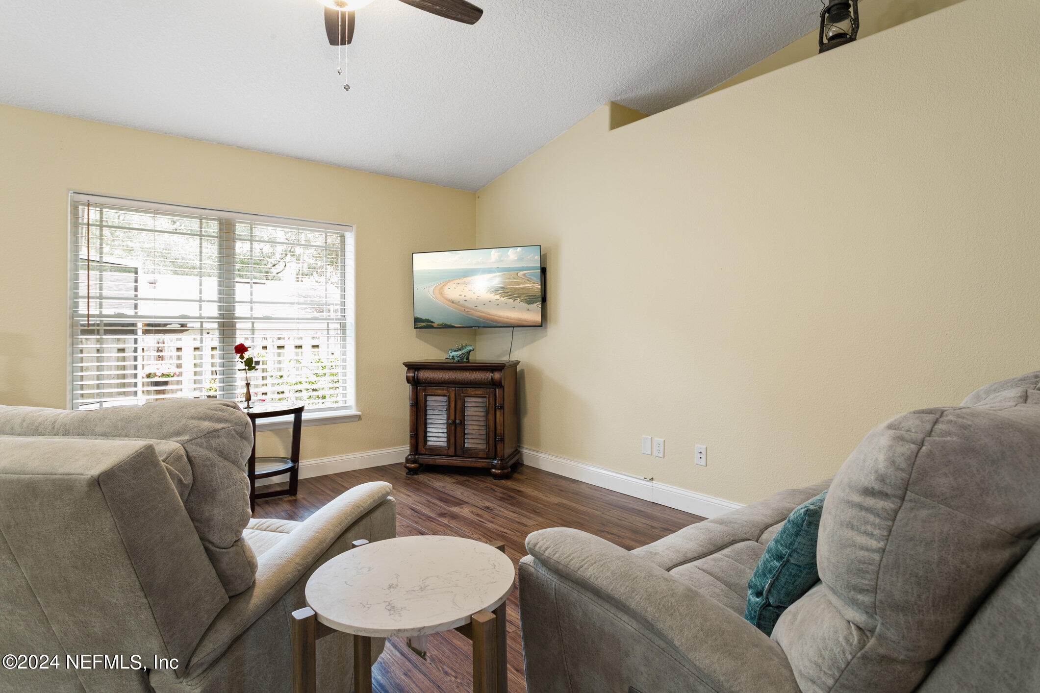 121 Cypress Road St. Augustine, FL 32086 - Photo 15 of 60 a living room with furniture a fireplace and a floor to ceiling window