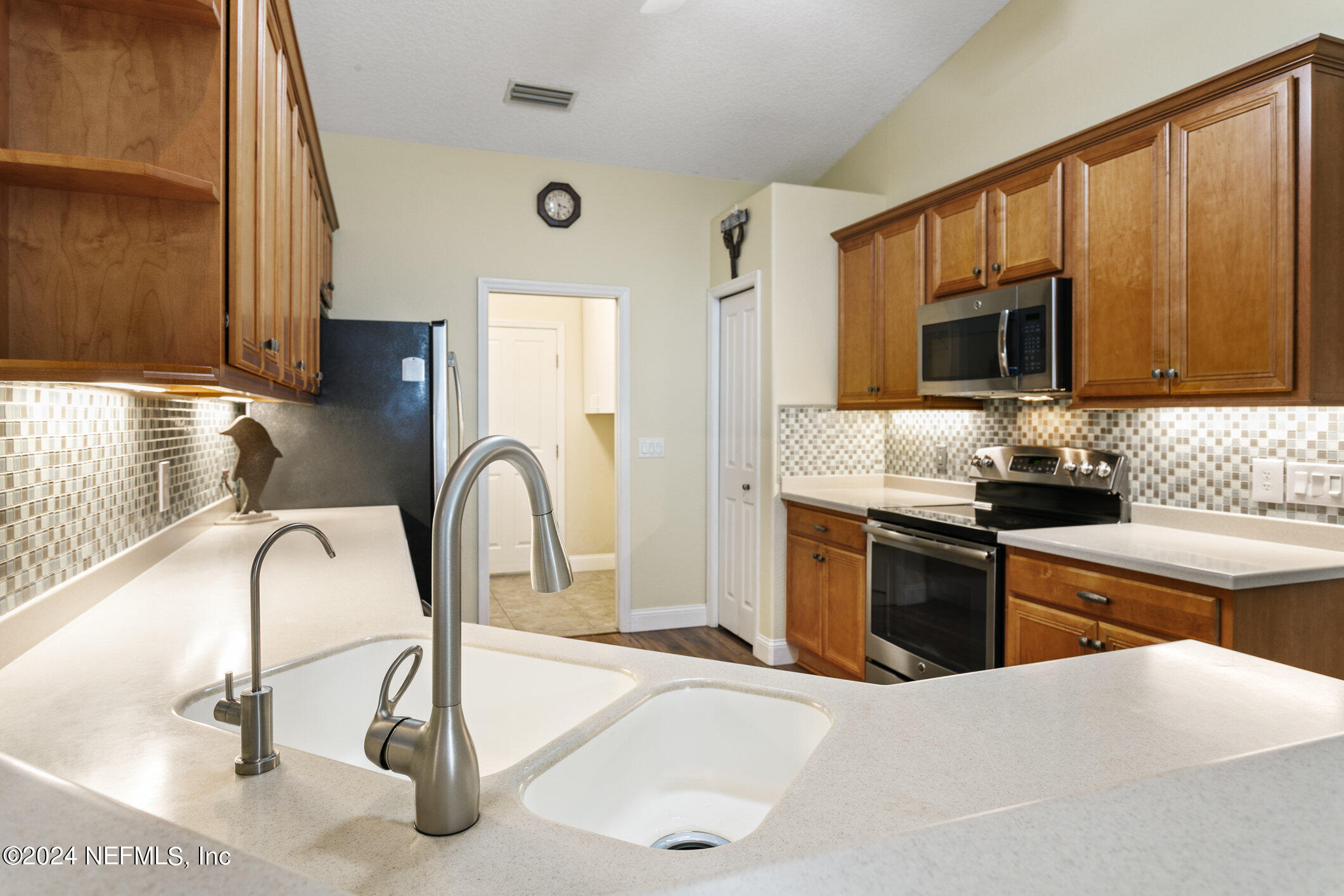 121 Cypress Road St. Augustine, FL 32086 - Photo 19 of 60 a kitchen with a stove a sink and a microwave