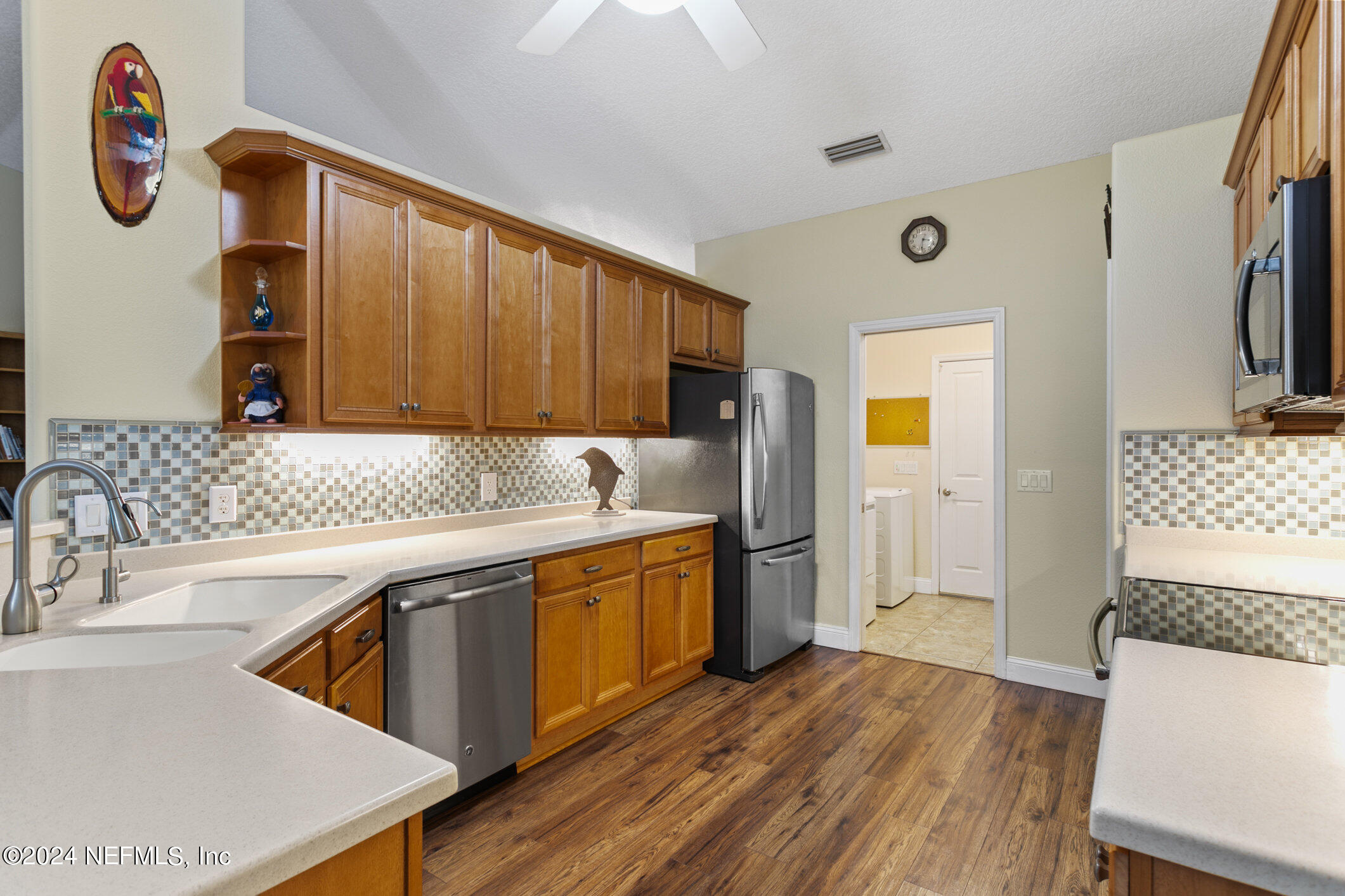 121 Cypress Road St. Augustine, FL 32086 - Photo 20 of 60 a kitchen with stainless steel appliances granite countertop a sink a stove a refrigerator and island with wooden floor