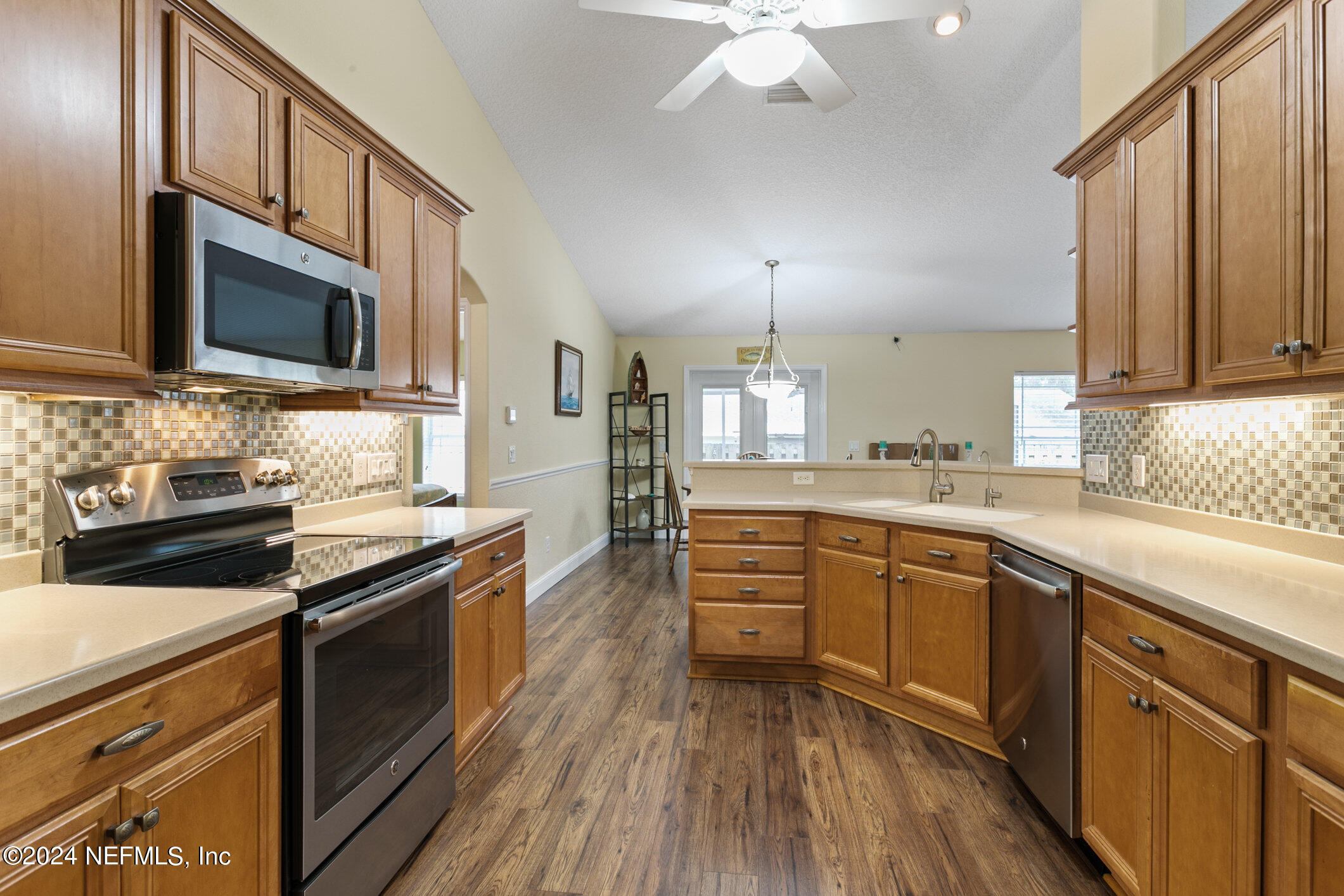 121 Cypress Road St. Augustine, FL 32086 - Photo 22 of 60 a kitchen with stainless steel appliances granite countertop a sink dishwasher stove and oven with wooden floor