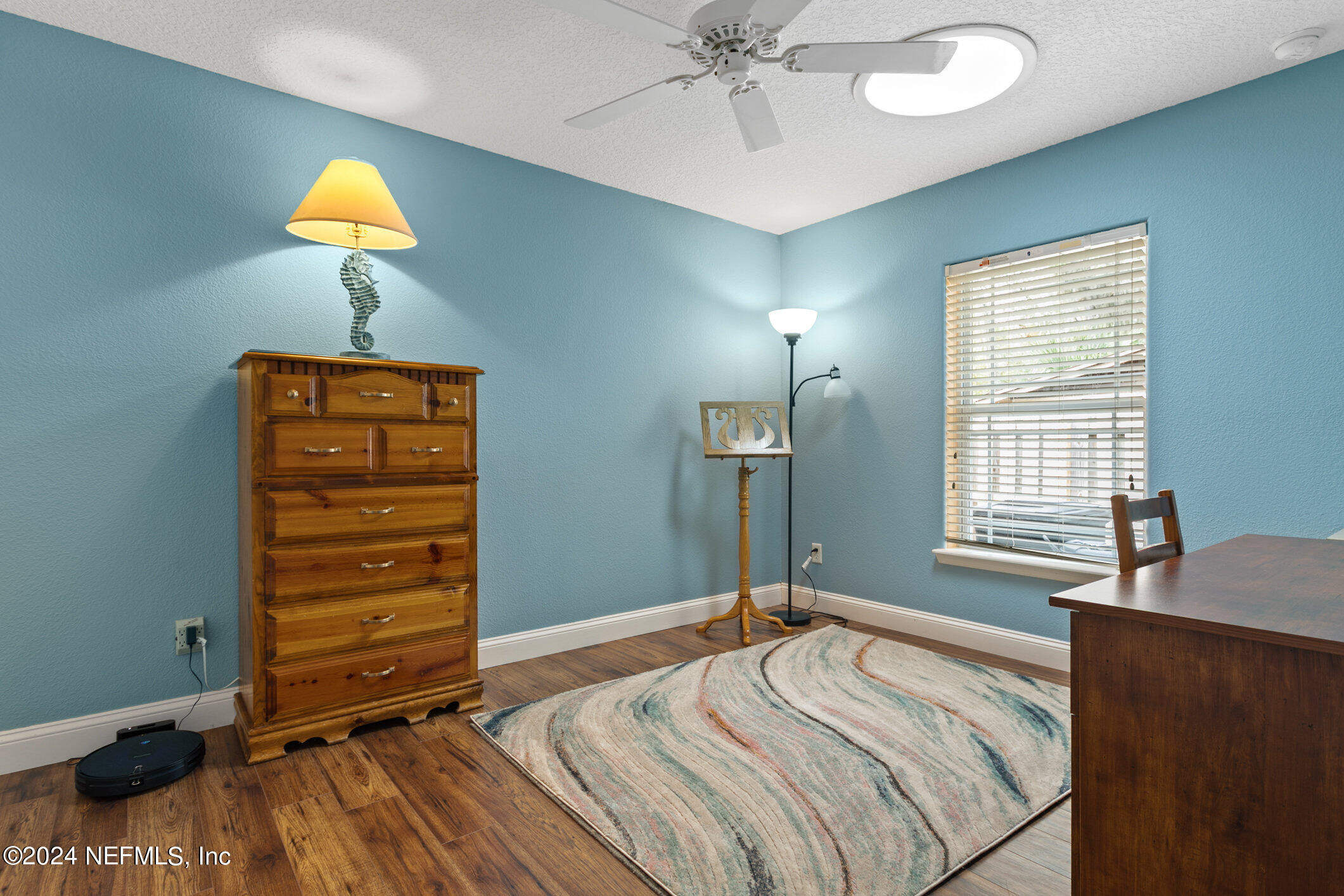 121 Cypress Road St. Augustine, FL 32086 - Photo 27 of 60 a bedroom with a bed and a chandelier