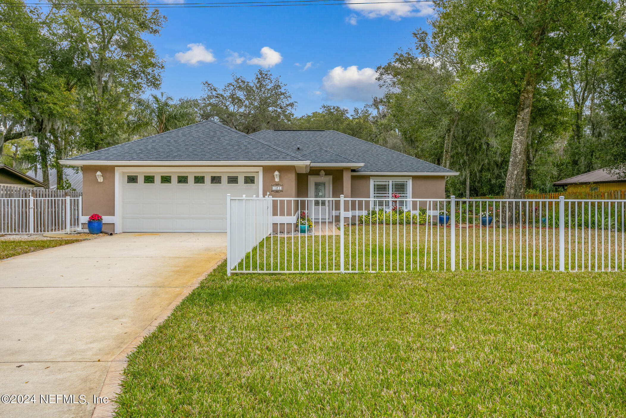 121 Cypress Road St. Augustine, FL 32086 - Photo 3 of 60 a front view of a house with a garden and plants