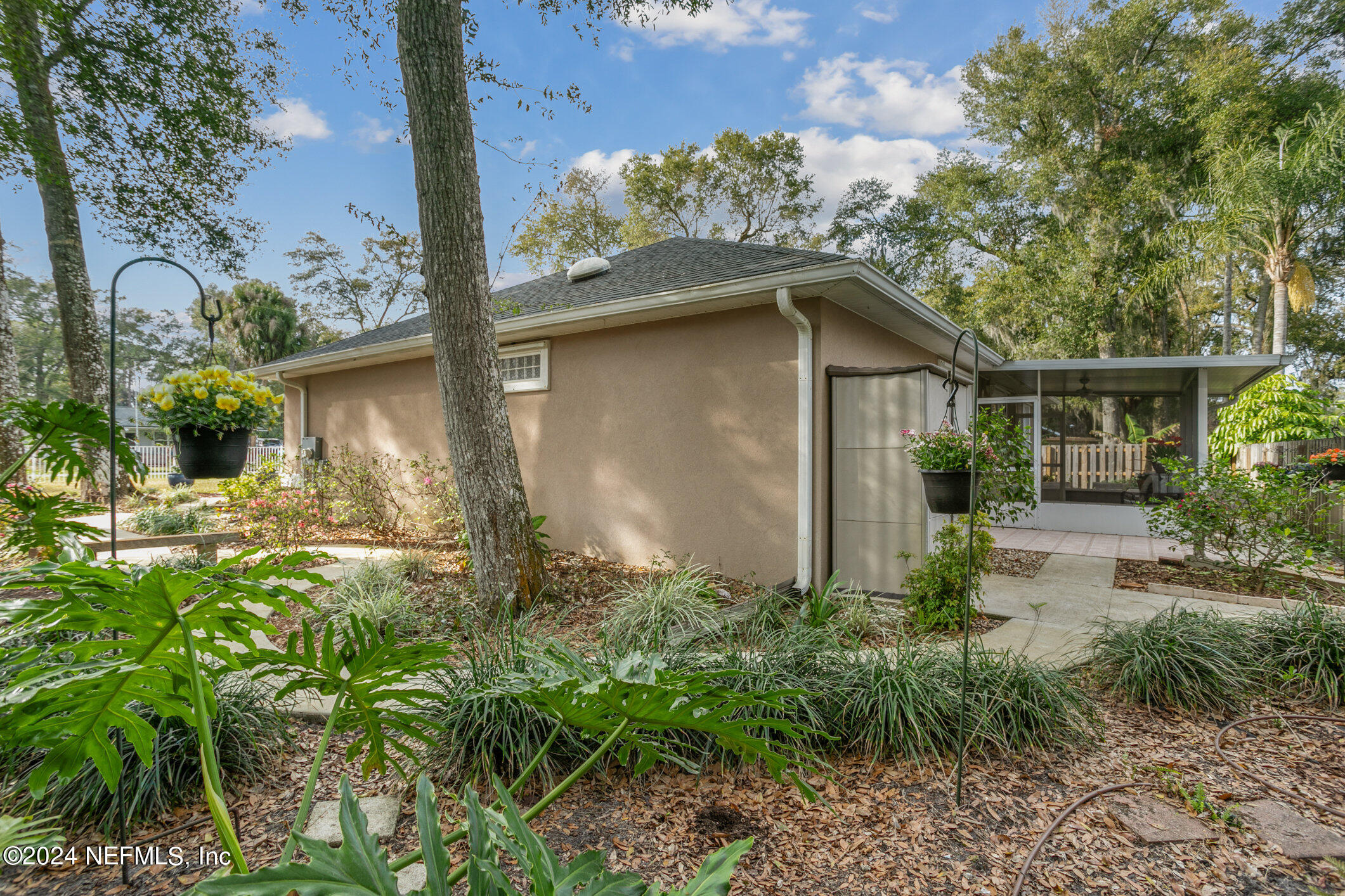 121 Cypress Road St. Augustine, FL 32086 - Photo 37 of 60 a backyard of a house with plants and outdoor seating