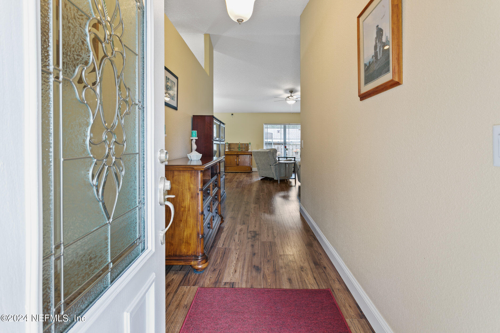 121 Cypress Road St. Augustine, FL 32086 - Photo 6 of 60 a view of a hallway with wooden floor and staircase