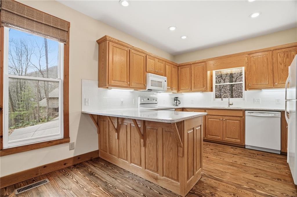 35 Red Oak Point Big Canoe, GA 30143 - Photo 17 of 62 a kitchen with granite countertop a sink cabinets stainless steel appliances and a window