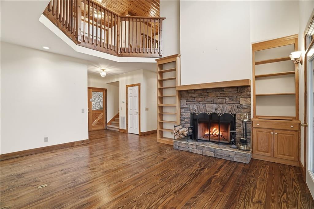 35 Red Oak Point Big Canoe, GA 30143 - Photo 10 of 62 a view of an empty room with wooden floor fireplace and a window