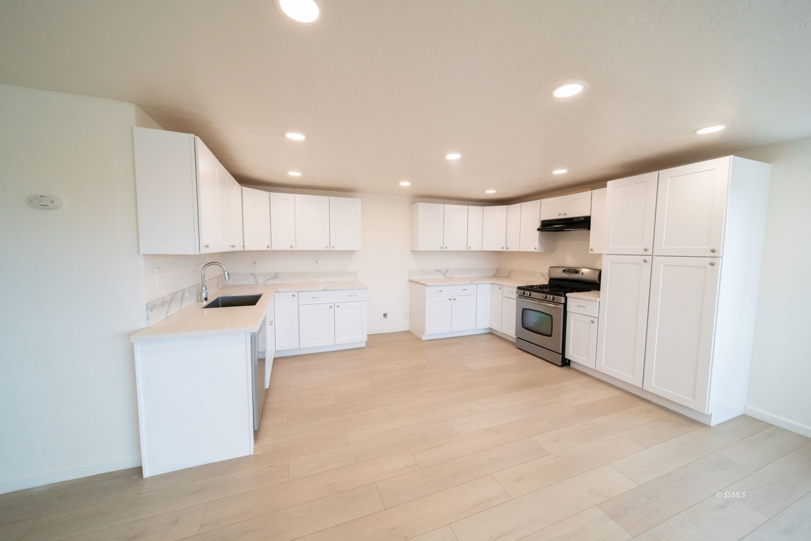 1424 Rademacher Way Ridgecrest, CA 93555 - Photo 7 of 23 a kitchen with white cabinets and refrigerator