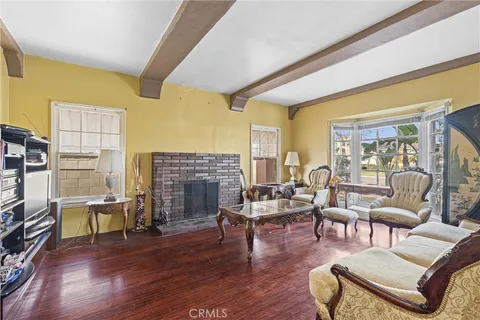 a living room with fireplace furniture and a floor to ceiling window