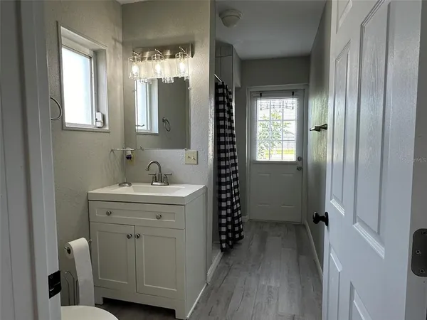 a bathroom with a sink a toilet and a mirror