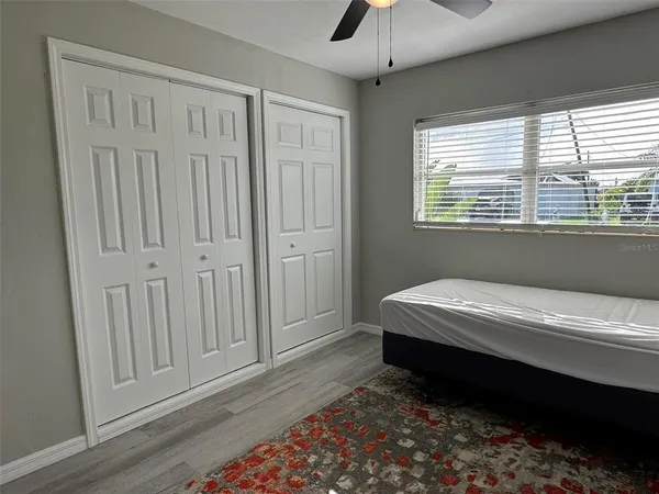 a bedroom with a bed and a window