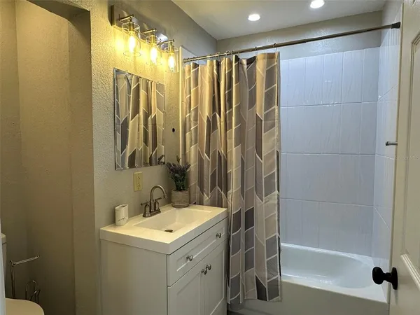 a bathroom with a shower curtain and a sink