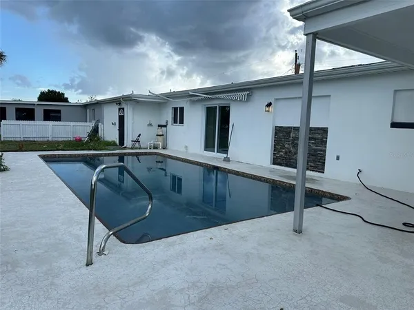a view of a swimming pool with a yard