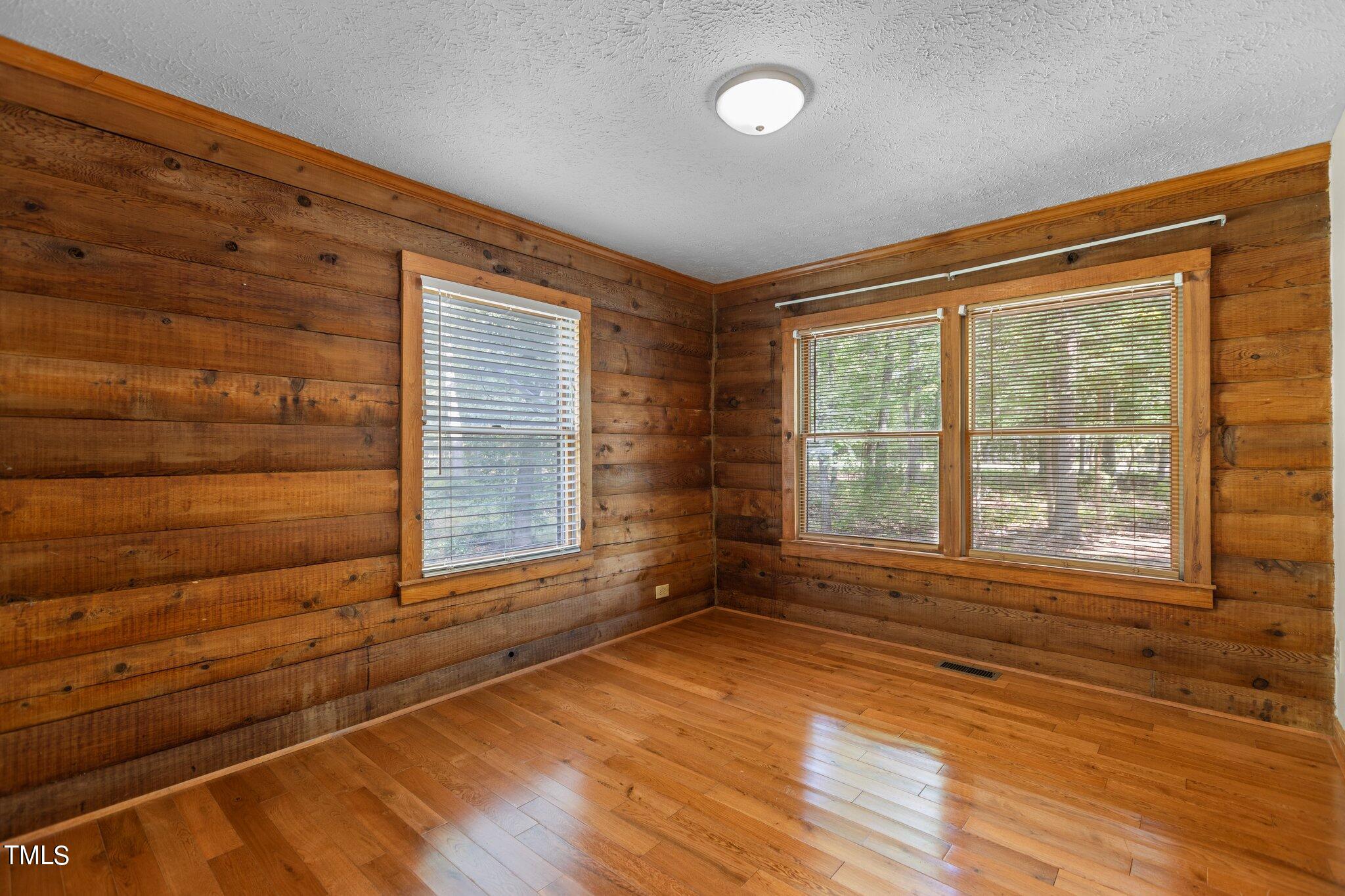1819 Chambers Loop Road Timberlake, NC 27583 - Photo 13 of 41 a view of an empty room with wooden floor and a window