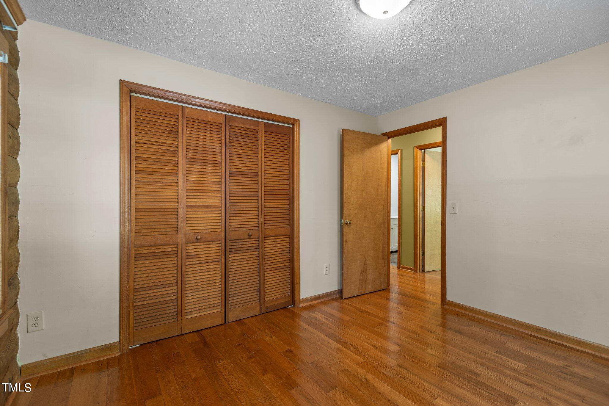 1819 Chambers Loop Road Timberlake, NC 27583 - Photo 14 of 41 an empty room with wooden floor and closet