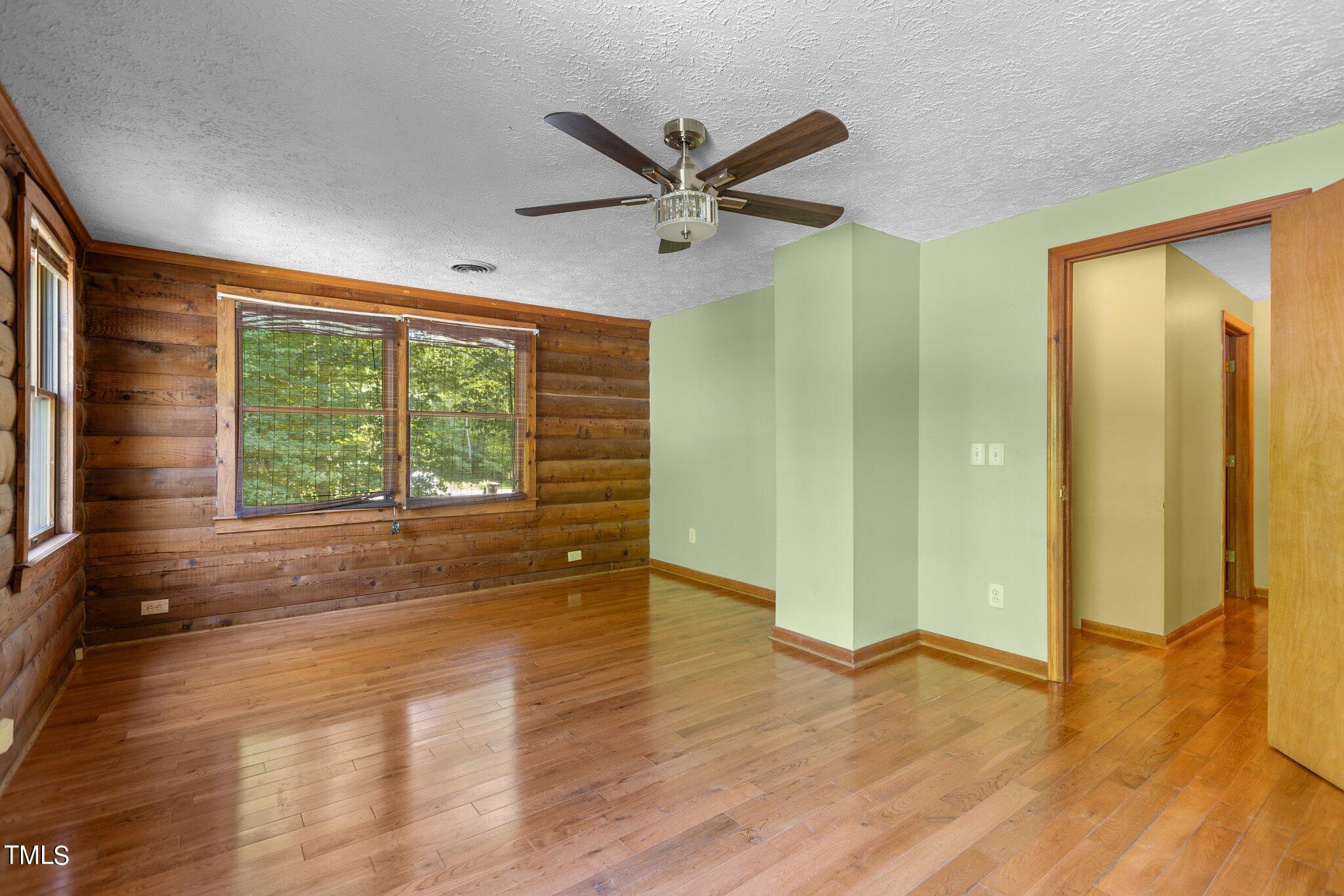1819 Chambers Loop Road Timberlake, NC 27583 - Photo 17 of 41 a view of an empty room with wooden floor and a window