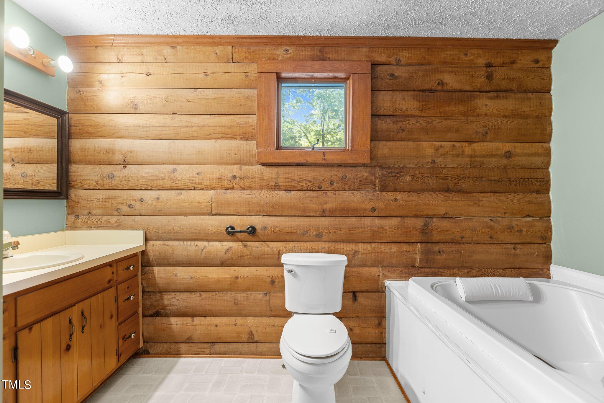 1819 Chambers Loop Road Timberlake, NC 27583 - Photo 20 of 41 a bathroom with a granite countertop toilet and a sink
