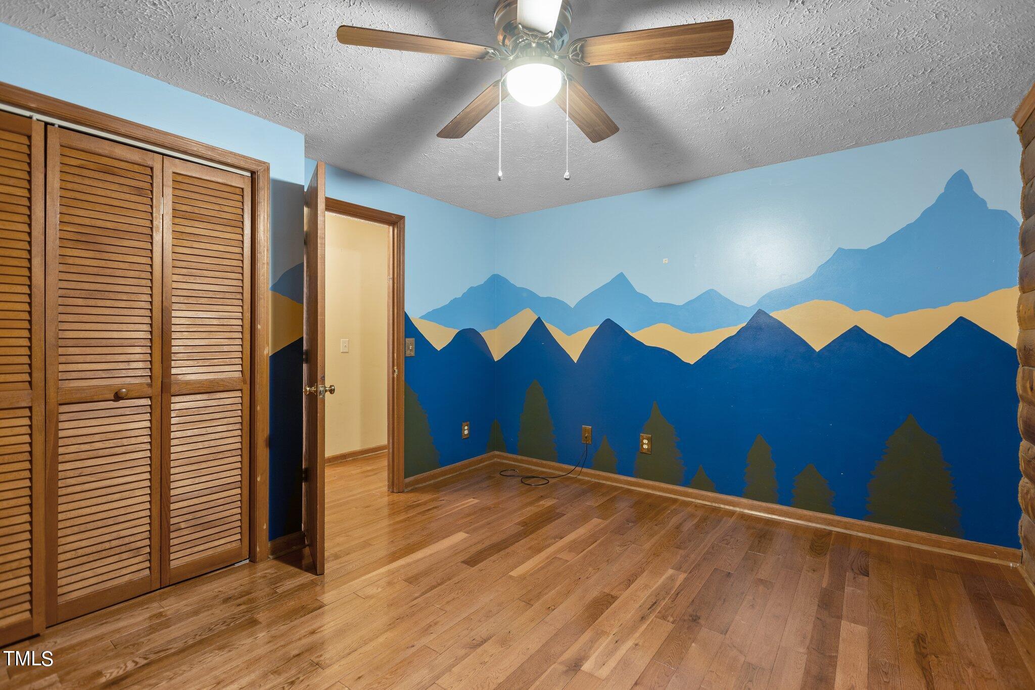 1819 Chambers Loop Road Timberlake, NC 27583 - Photo 23 of 41 a view of an empty room with wooden floor and a chandelier