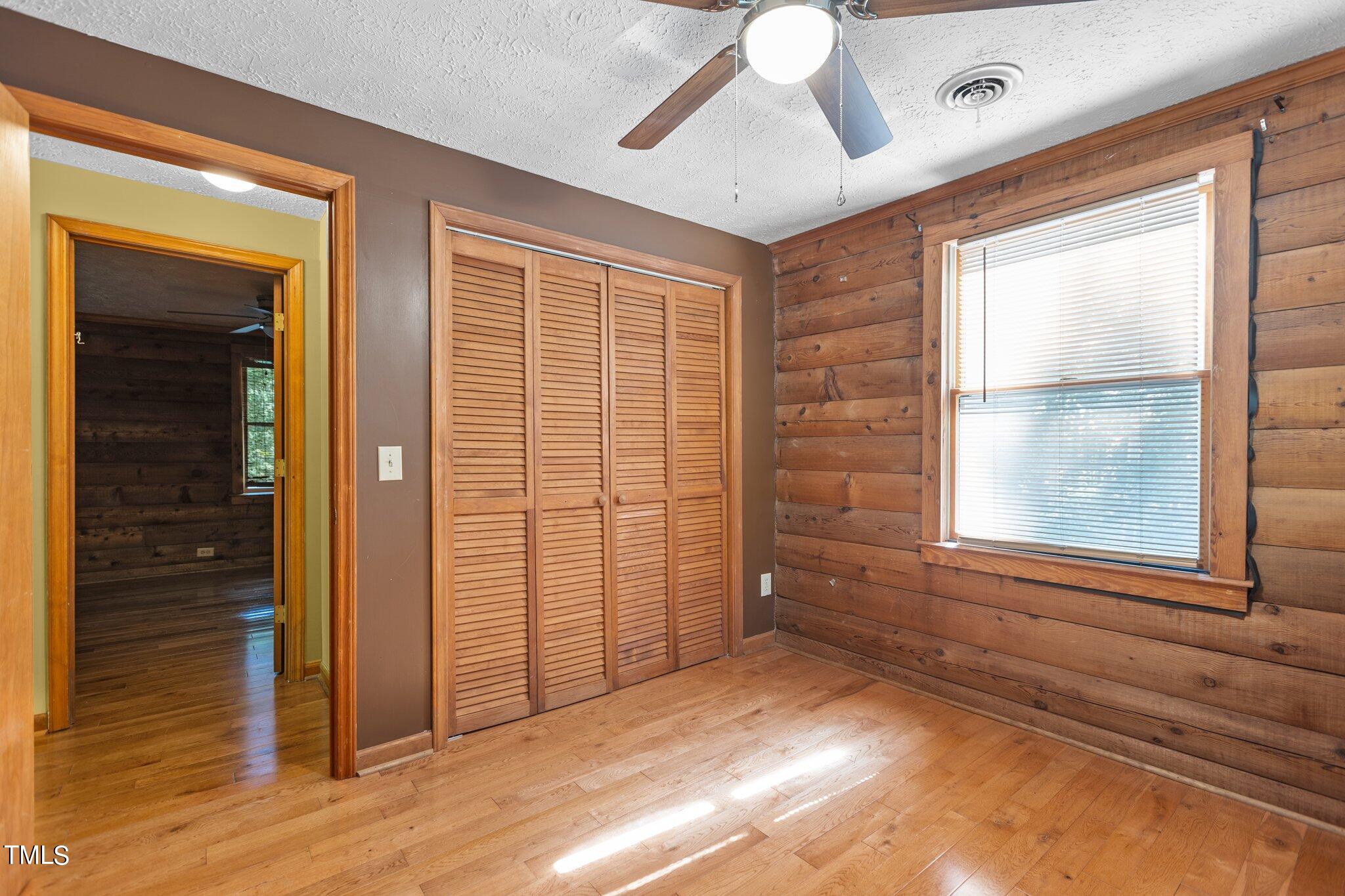 1819 Chambers Loop Road Timberlake, NC 27583 - Photo 25 of 41 en empty room with window and wooden floor