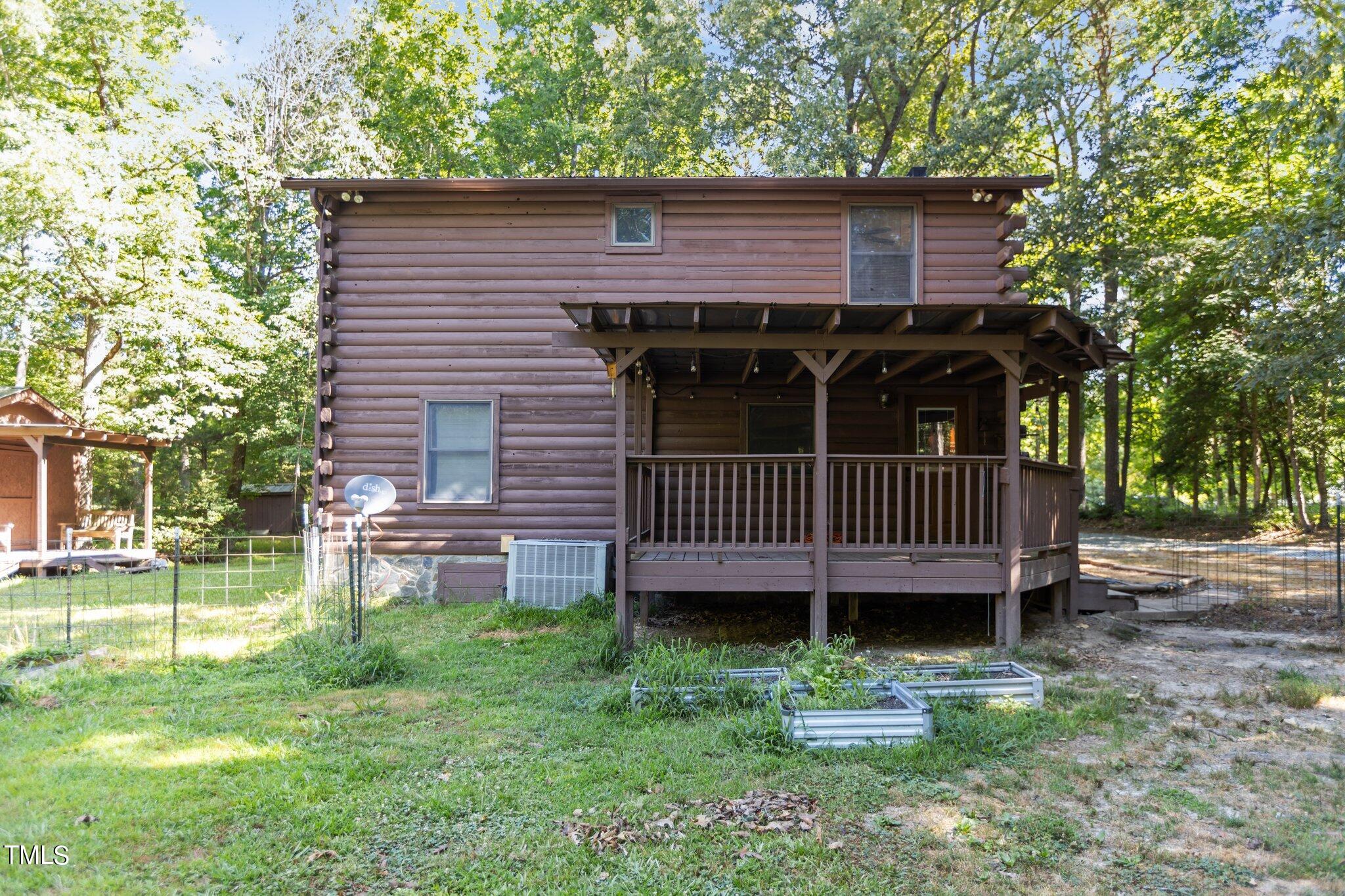 1819 Chambers Loop Road Timberlake, NC 27583 - Photo 28 of 41 a view of a deck with a table and chairs and a large tree