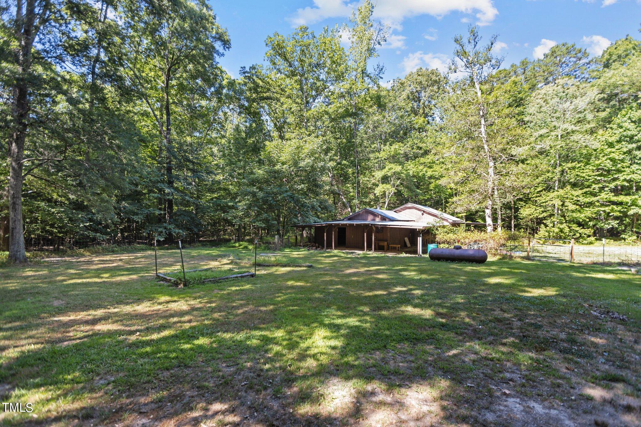 1819 Chambers Loop Road Timberlake, NC 27583 - Photo 34 of 41 a backyard of a house with table and chairs