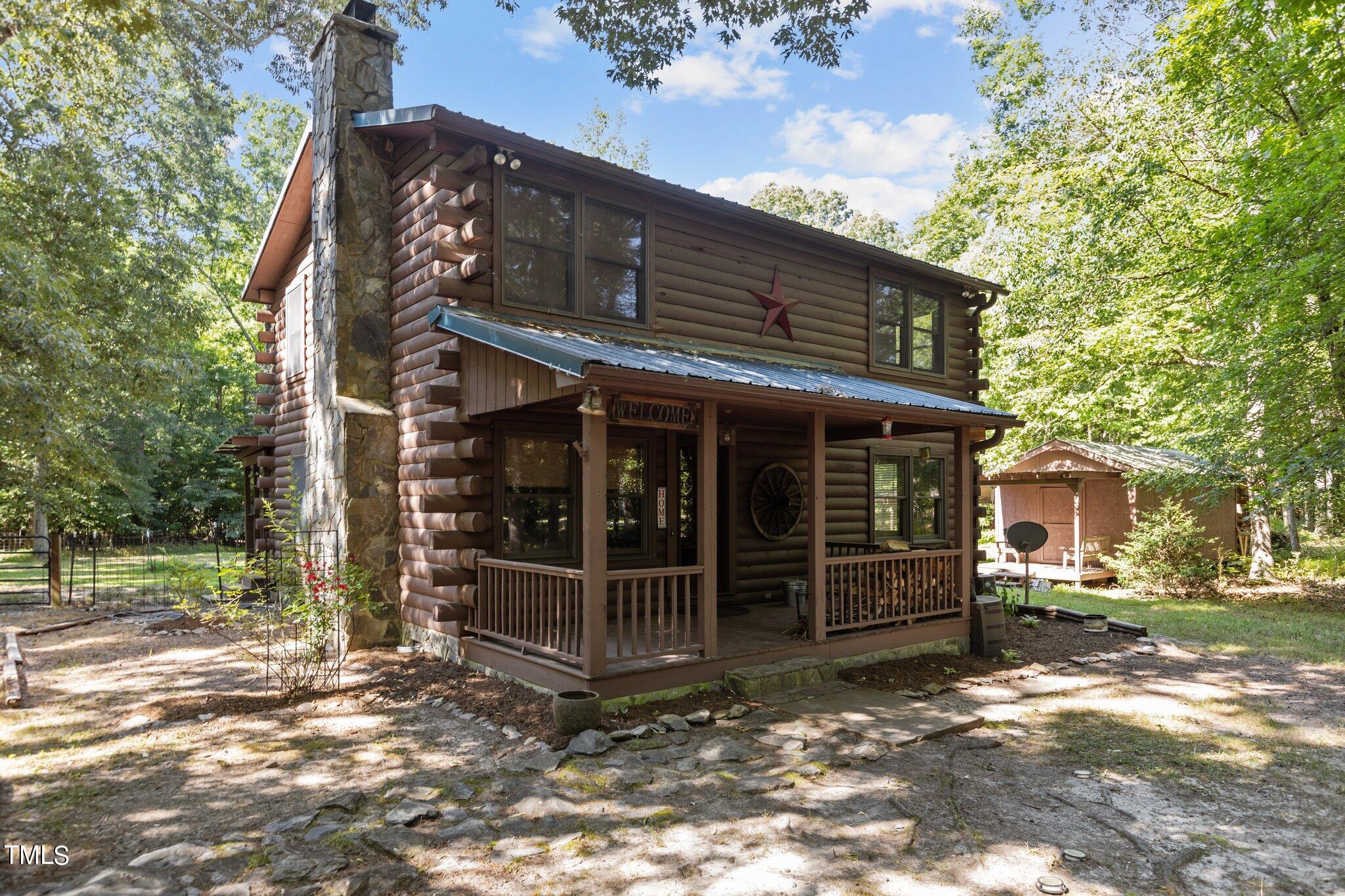 1819 Chambers Loop Road Timberlake, NC 27583 - Photo 36 of 41 a view of a house with a large window and a large tree