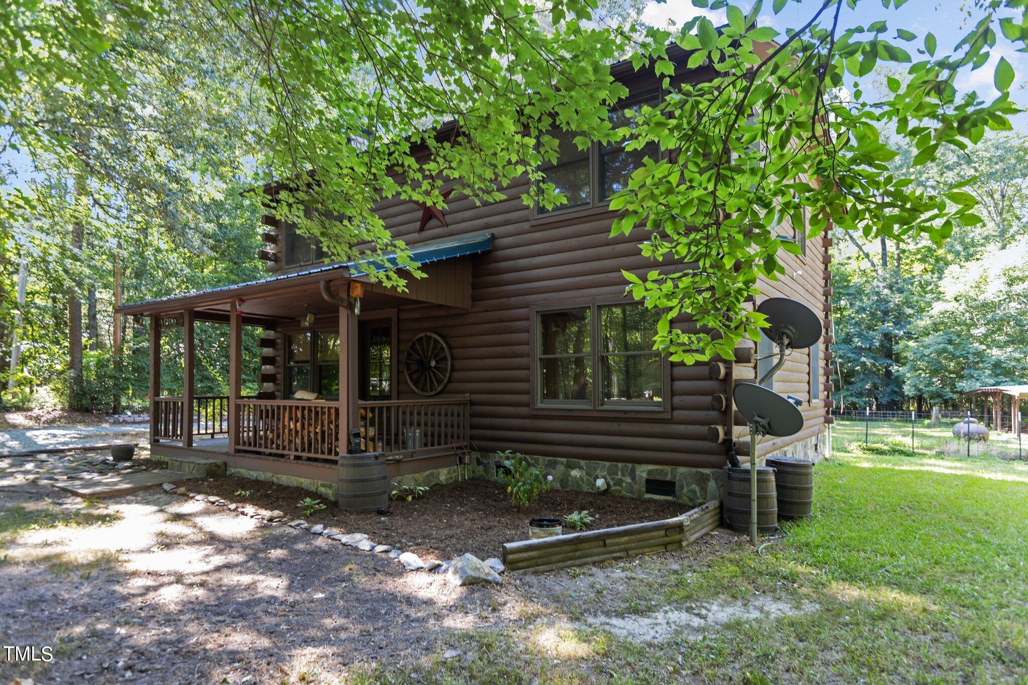 1819 Chambers Loop Road Timberlake, NC 27583 - Photo 37 of 41 a view of a chair and table in backyard of the house