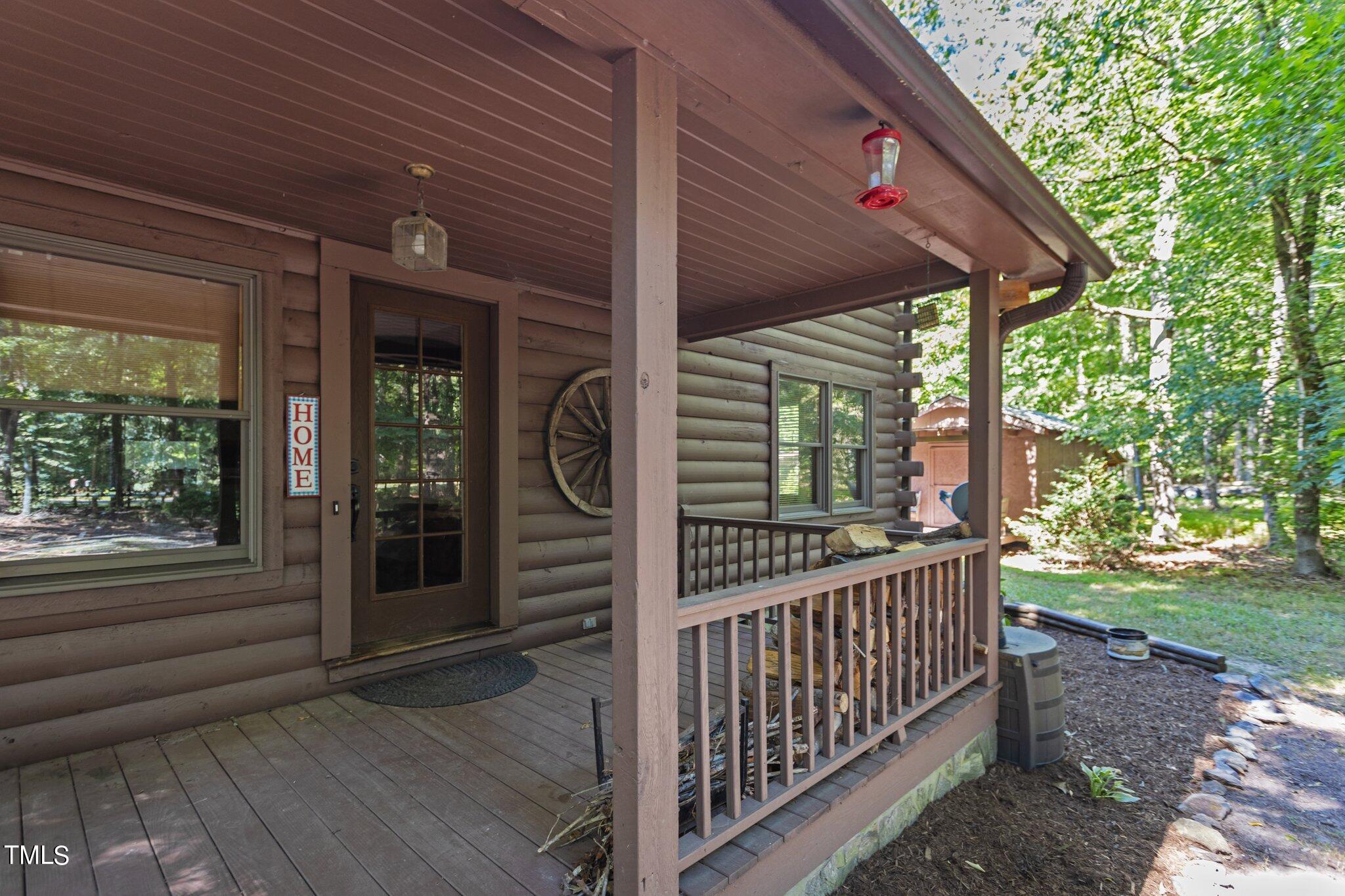 1819 Chambers Loop Road Timberlake, NC 27583 - Photo 38 of 41 a view of a porch with wooden floor and floor to ceiling window