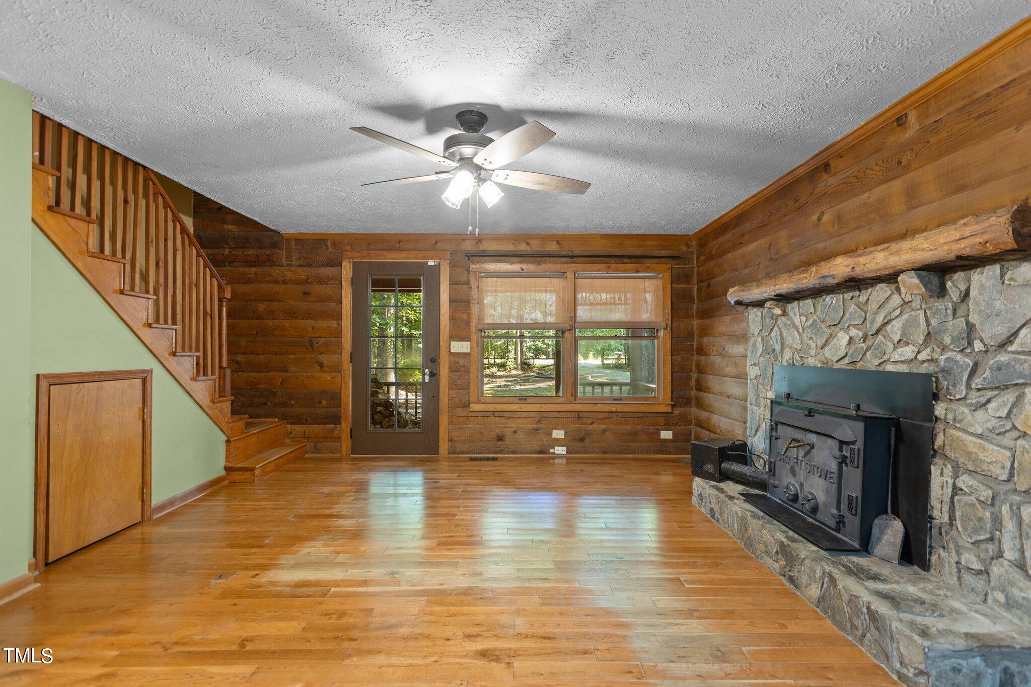 1819 Chambers Loop Road Timberlake, NC 27583 - Photo 4 of 41 a view of an empty room with wooden floor fireplace and a window