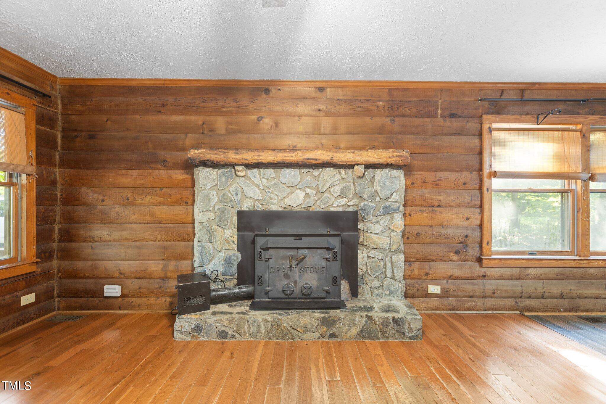 1819 Chambers Loop Road Timberlake, NC 27583 - Photo 5 of 41 a living room with a fireplace and windows