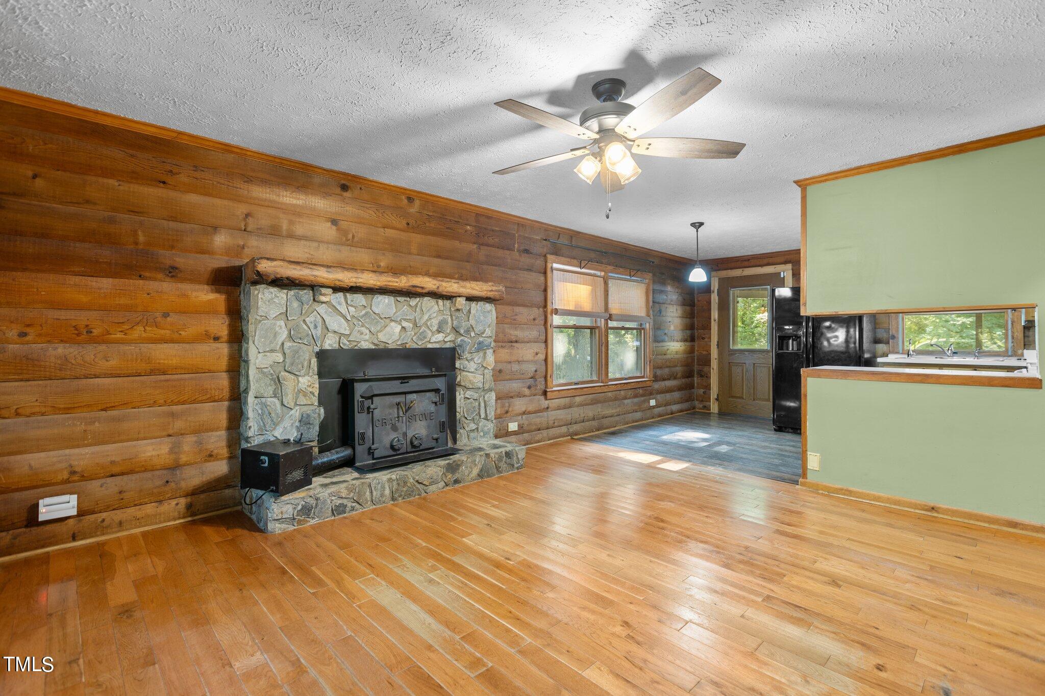 1819 Chambers Loop Road Timberlake, NC 27583 - Photo 6 of 41 a view of an empty room with a fireplace and a window